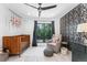 Charming Bedroom with a crib, cozy chair, and patterned accent wall at 2838 Tennyson St, Denver, CO 80212