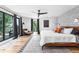 This bedroom features hardwood floors, a patterned accent wall, and large windows for lots of natural light at 2838 Tennyson St, Denver, CO 80212