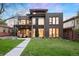 Modern home featuring a well-manicured lawn, large windows, and a second-story balcony at 2838 Tennyson St, Denver, CO 80212