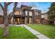 Contemporary home featuring a manicured lawn, a balcony, and outdoor seating at 2838 Tennyson St, Denver, CO 80212