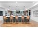 Spacious kitchen with a large island, pendant lighting, and bar stool seating at 2838 Tennyson St, Denver, CO 80212