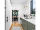 Modern kitchen featuring sleek green cabinets and gold fixtures, blending style and functionality at 2838 Tennyson St, Denver, CO 80212
