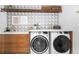 Well-organized laundry room with modern appliances, decorative tile, and ample storage space at 2838 Tennyson St, Denver, CO 80212