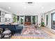 Open living room with stylish rug, modern furnishings, dark accent wall, and hardwood floors at 2838 Tennyson St, Denver, CO 80212
