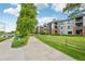 Scenic view of condos nestled along a tree-lined walkway and green lawn at 2727 Folsom St # 303, Boulder, CO 80304