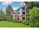 Well-kept condo building with brick accents, surrounded by trees and lawn at 2727 Folsom St # 303, Boulder, CO 80304
