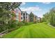 Beautiful condo building with a lush green lawn and mature trees at 2727 Folsom St # 303, Boulder, CO 80304