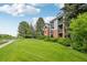 Inviting exterior of condo building with manicured lawn and mature trees at 2727 Folsom St # 303, Boulder, CO 80304
