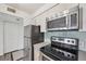 Well-equipped kitchen with modern appliances, sleek countertops, and ample cabinet space at 2727 Folsom St # 303, Boulder, CO 80304