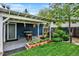 Backyard features a covered patio with a built in grill surrounded by lush landscaping and grass at 13496 Alcott Way, Broomfield, CO 80020