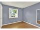 Cozy bedroom featuring a window with bright natural light and hardwood floors at 13496 Alcott Way, Broomfield, CO 80020