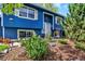 Close-up of the front exterior showing the blue siding, front door, and landscaped front yard at 13496 Alcott Way, Broomfield, CO 80020