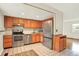 Well-equipped kitchen with stainless steel appliances, wood cabinetry and tile flooring at 13496 Alcott Way, Broomfield, CO 80020