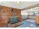 Living room showcasing a wood-burning stove, brick accent wall, and rustic charm at 13496 Alcott Way, Broomfield, CO 80020