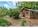 Wooden shed surrounded by bark mulch with a small platform and green landscaping at 13496 Alcott Way, Broomfield, CO 80020