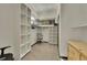 Bright walk-in closet with custom shelving and a small window displaying a stunning view of the surrounding landscape at 55 Blue Flag Dr, Breckenridge, CO 80424