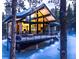Modern home featuring a deck, large windows, and surrounded by a snowy forest at 55 Blue Flag Dr, Breckenridge, CO 80424