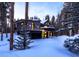 Contemporary home featuring a two-car garage and a balcony covered in winter snow at 55 Blue Flag Dr, Breckenridge, CO 80424