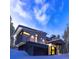Exterior view of a modern residence with a two-car garage and snowy surroundings at 55 Blue Flag Dr, Breckenridge, CO 80424