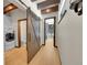 Hallway featuring a wooden barn door leading to a bathroom and laundry area at 55 Blue Flag Dr, Breckenridge, CO 80424