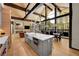 Bright, open-concept kitchen boasts a spacious island, stainless steel appliances, and large windows with scenic views at 55 Blue Flag Dr, Breckenridge, CO 80424