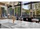 Modern kitchen and dining area with views of the forest, stylish fixtures, and an open layout at 55 Blue Flag Dr, Breckenridge, CO 80424