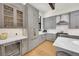 Stylish kitchen features gray cabinets with wine cooler, stainless steel appliances, and wood floors at 55 Blue Flag Dr, Breckenridge, CO 80424