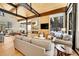 Spacious living room with fireplace, wood accents, and large windows overlooking the snow-covered forest at 55 Blue Flag Dr, Breckenridge, CO 80424
