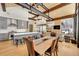 Open concept living space with exposed beams, modern lighting, and a fireplace for a rustic and contemporary charm at 55 Blue Flag Dr, Breckenridge, CO 80424