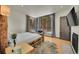 Bright bedroom featuring a unique log bed frame, natural light, and an adjacent fireplace for a cozy retreat at 55 Blue Flag Dr, Breckenridge, CO 80424