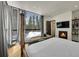 Sunlit bedroom featuring an eye-catching log bed frame and views of snow-covered pines, complete with a fireplace at 55 Blue Flag Dr, Breckenridge, CO 80424