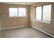 Bright bedroom with hardwood flooring, neutral walls, and plenty of natural light from large windows at 875 S Quebec St # 25, Denver, CO 80247