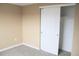 This bedroom features neutral walls, carpeted floors, and a closet with sliding doors at 875 S Quebec St # 25, Denver, CO 80247