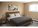 Cozy bedroom featuring a comfortable bed, modern art, and ample natural light from the window at 875 S Quebec St # 25, Denver, CO 80247