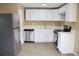 Modern kitchen with stainless steel appliances, white cabinetry, and sleek countertops at 875 S Quebec St # 25, Denver, CO 80247