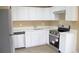 This kitchen features stainless steel appliances and white cabinets at 875 S Quebec St # 25, Denver, CO 80247