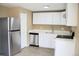 Modern kitchen featuring stainless steel appliances, white cabinets, and sleek countertops at 875 S Quebec St # 25, Denver, CO 80247