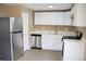 Updated kitchen features stainless steel appliances, and modern wood flooring at 875 S Quebec St # 25, Denver, CO 80247