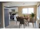 Bright kitchen and dining area with stainless steel appliances and a dining table set for four at 875 S Quebec St # 25, Denver, CO 80247