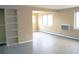 Open-concept living room featuring built-in shelving, modern windows and hardwood-style floors at 875 S Quebec St # 25, Denver, CO 80247