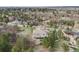 Sweeping aerial view of a beautiful home surrounded by a lush green landscape and mature trees at 6398 Lost Canyon Ranch Rd, Castle Rock, CO 80104