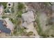 Stunning aerial view of the home showcasing its unique architecture, well-maintained landscaping, and long driveway at 6398 Lost Canyon Ranch Rd, Castle Rock, CO 80104