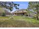 Expansive backyard featuring a manicured lawn, covered patio, and a two-story home with a second-story balcony at 6398 Lost Canyon Ranch Rd, Castle Rock, CO 80104