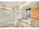 Bathroom featuring vanity with granite countertop, glass shower, and wood trim at 6398 Lost Canyon Ranch Rd, Castle Rock, CO 80104