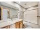 Bathroom featuring granite vanity top, large mirror, and shower with glass door at 6398 Lost Canyon Ranch Rd, Castle Rock, CO 80104