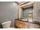 Bathroom featuring gray walls, wood cabinets, granite countertop, and tiled floors at 6398 Lost Canyon Ranch Rd, Castle Rock, CO 80104