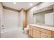 Bathroom with a single vanity, toilet and shower over tub with white tile at 6398 Lost Canyon Ranch Rd, Castle Rock, CO 80104