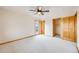 Light-filled bedroom with plush carpeting, fan and private access to balcony at 6398 Lost Canyon Ranch Rd, Castle Rock, CO 80104