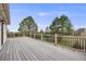 Large deck featuring railing with views of the greenery at 6398 Lost Canyon Ranch Rd, Castle Rock, CO 80104