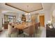 Elegant dining room with a wooden table, chandelier, and seamless flow to living area at 6398 Lost Canyon Ranch Rd, Castle Rock, CO 80104